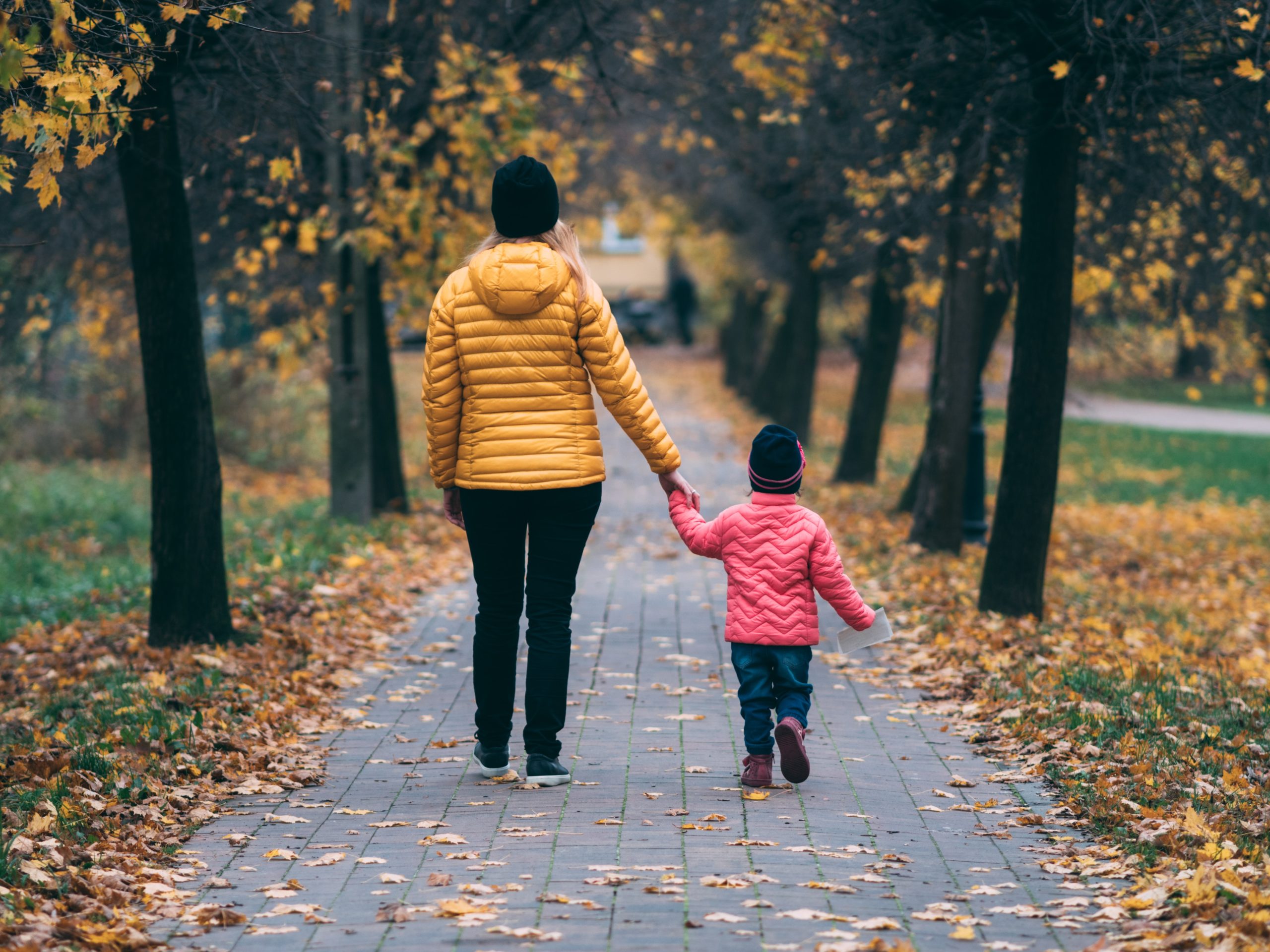 Family walking through Autumn trees