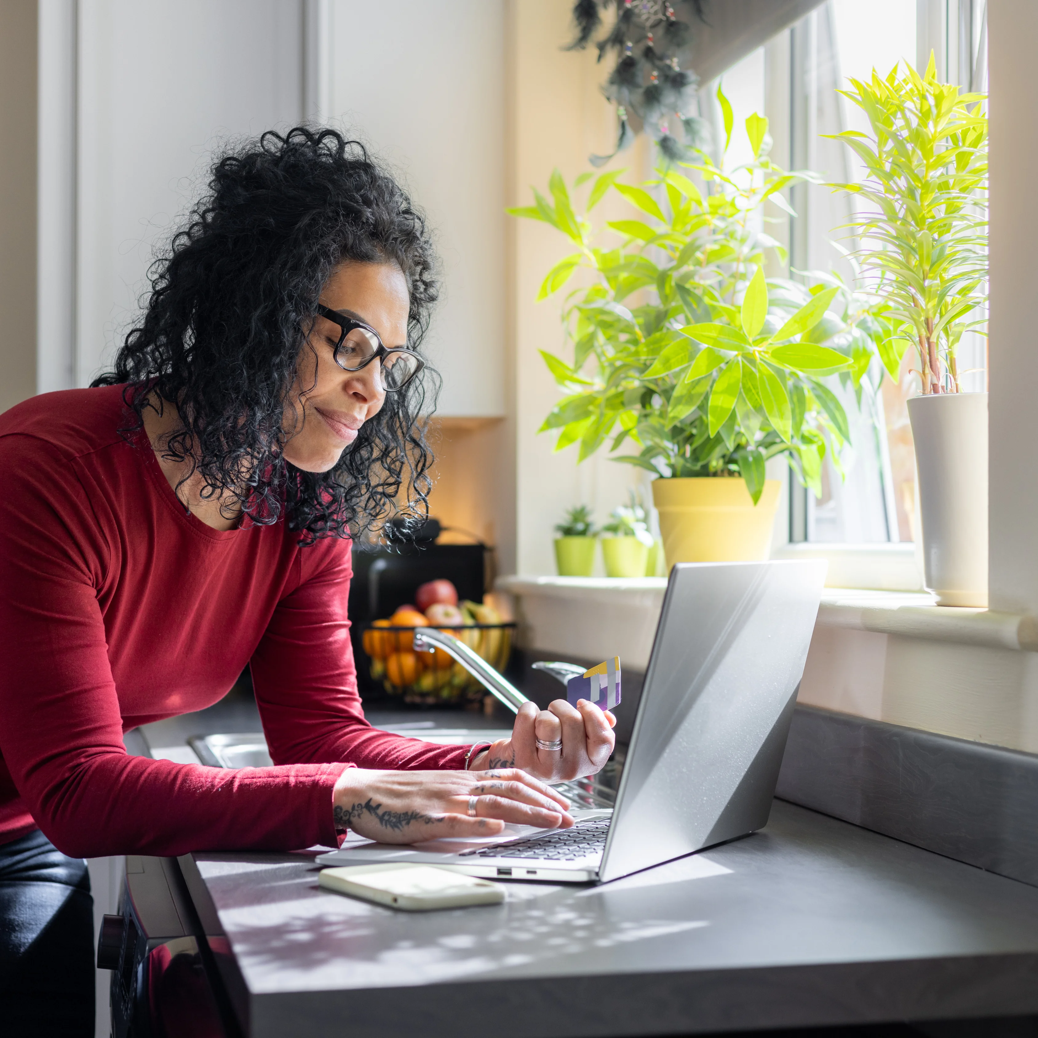 Lady on laptop near sink