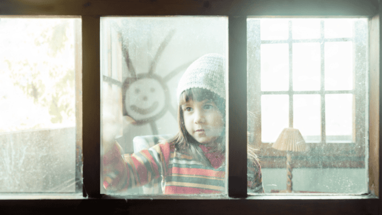 Child looking out a window
